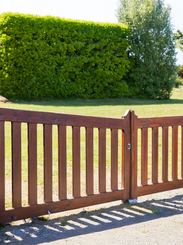 Bespoke timber garden fence and gate in a lawn